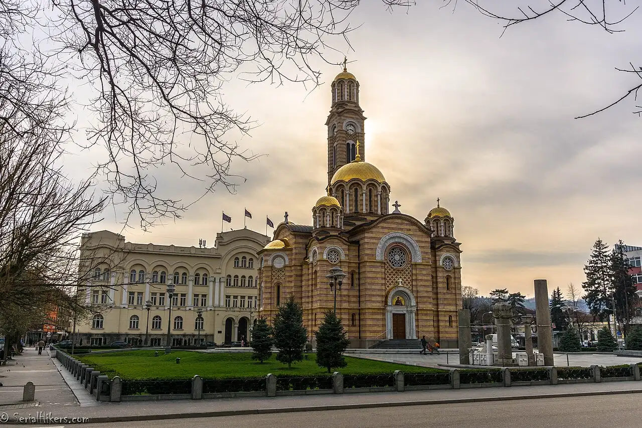 A view over the rooftops of Banja Luka with the golden Orthodox cathedral and green hills beyond