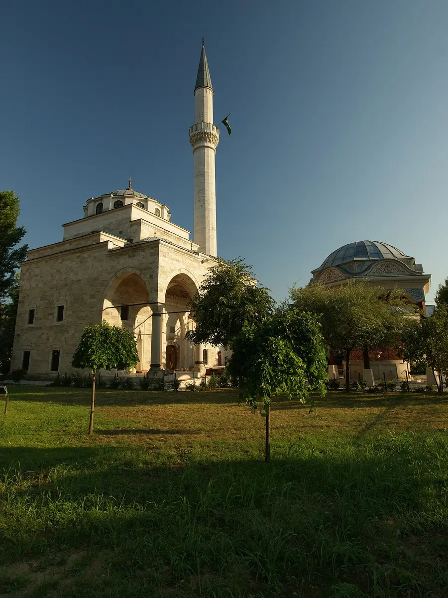 The rebuilt Ferhat Pasha Mosque (Ferhadija) in Banja Luka, its stone minaret and dome against a blue sky