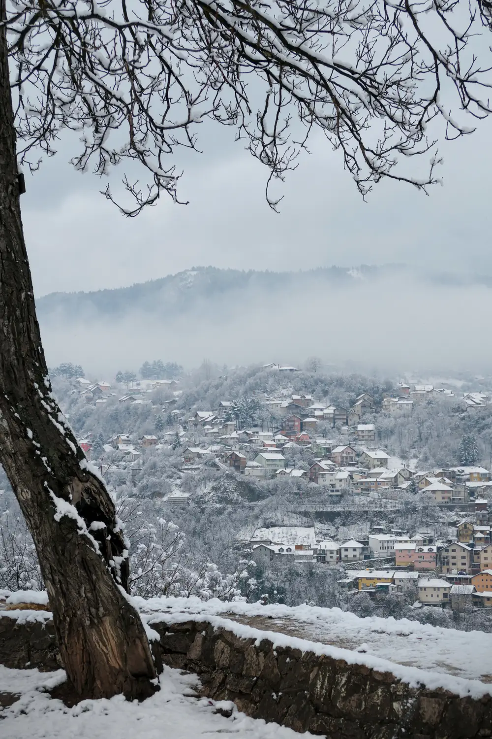 Snow covering the rooftops and minarets of Sarajevo in winter