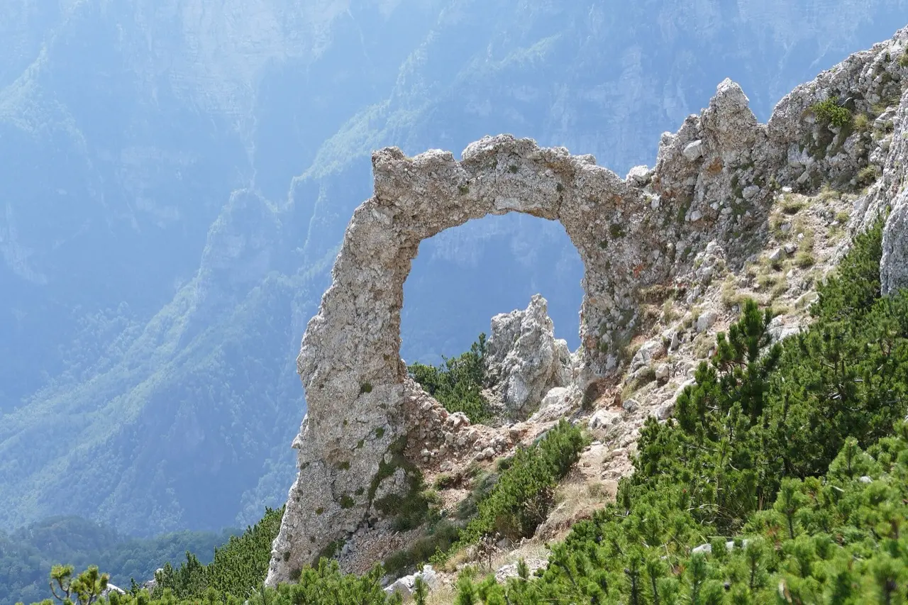 The natural limestone rock arch of Hajdučka vrata on Čvrsnica against a clear sky