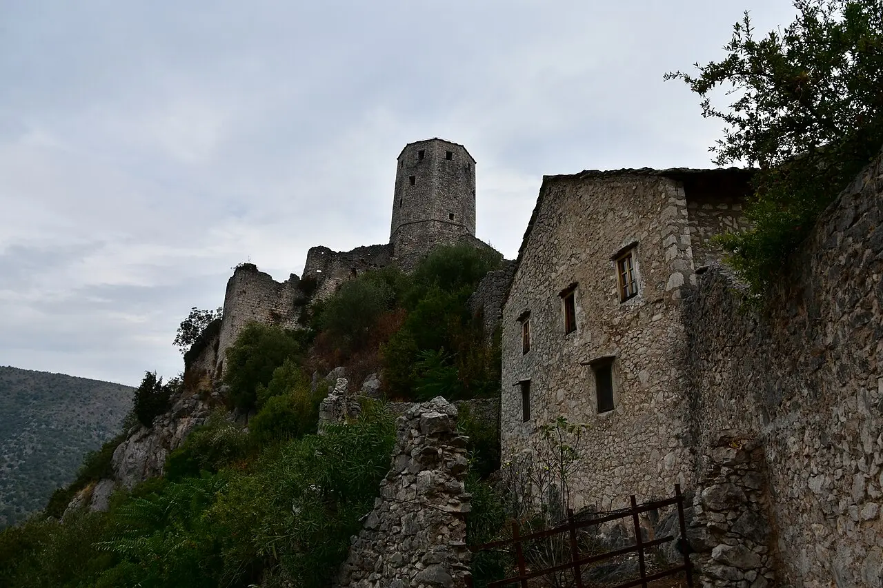 The Ottoman hilltop town of Počitelj climbing in pale stone to its fortress above the Neretva valley