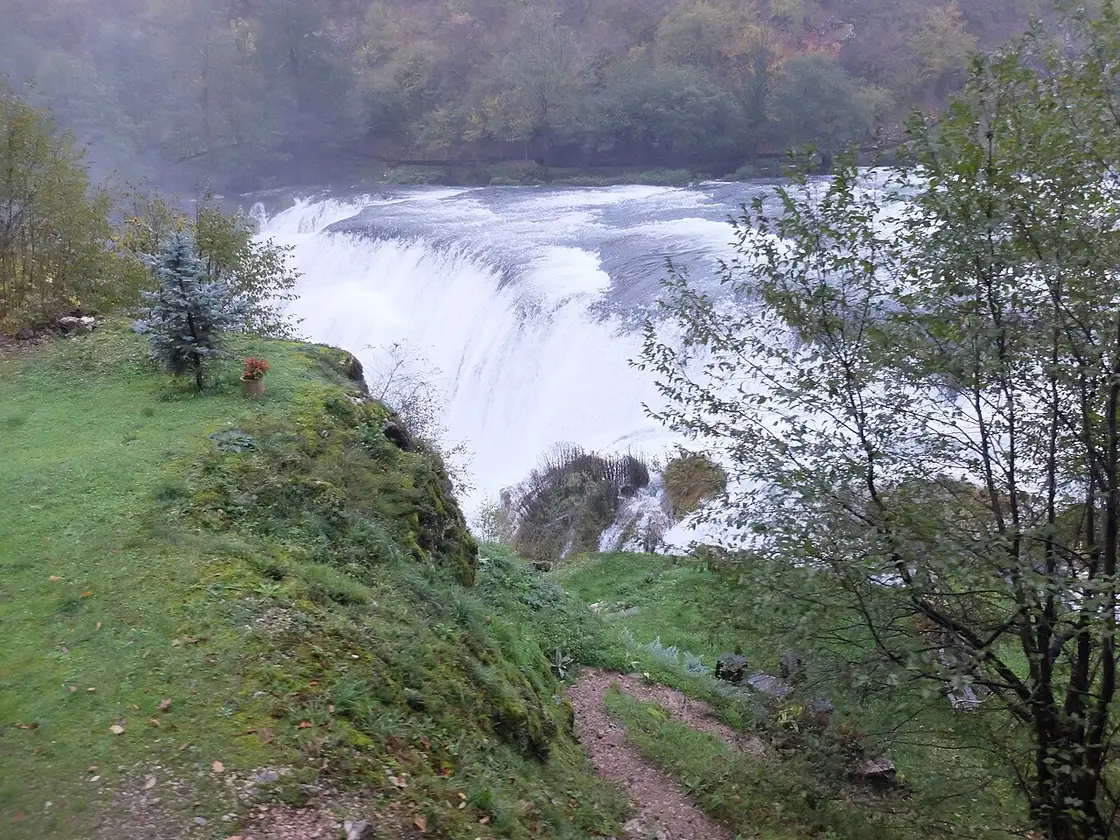 Clear green pools and low cascades of the Una river inside Una National Park, thick forest on the banks