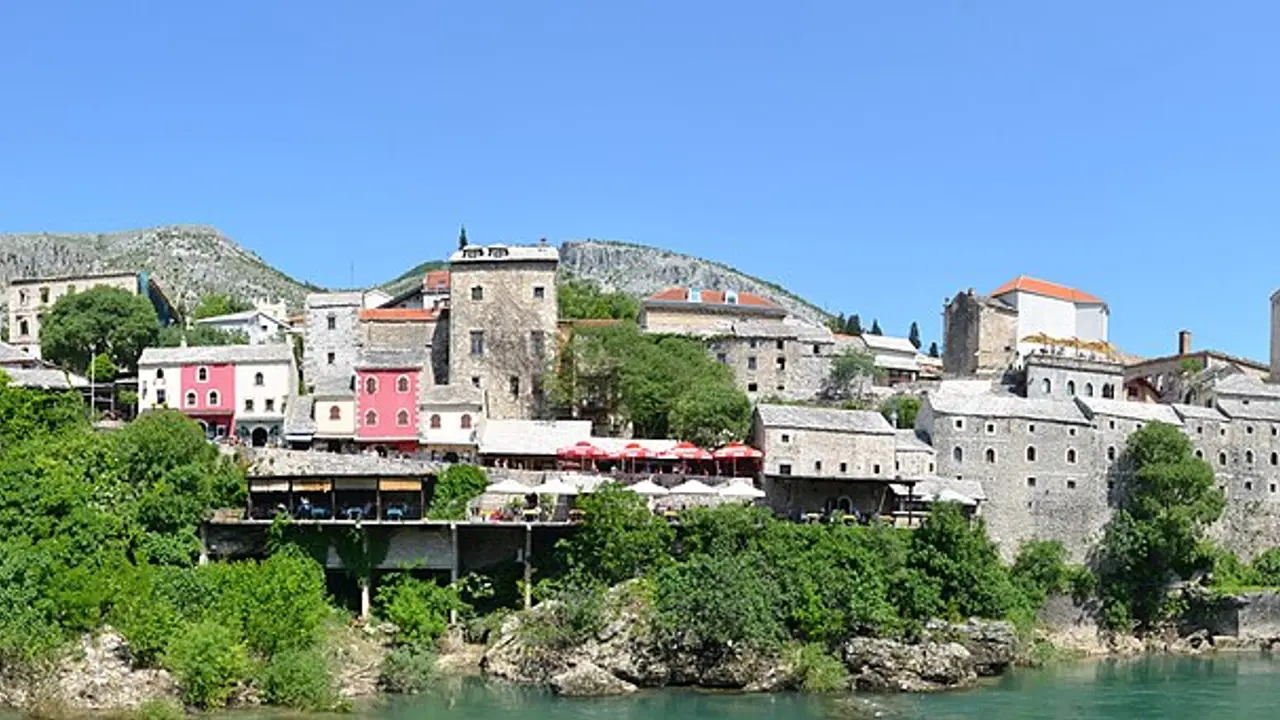 Wide panorama of Mostar and the Neretva valley in Herzegovina, minarets and stone houses under the surrounding hills