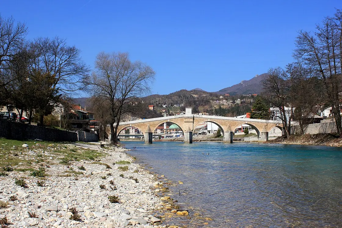 The restored Ottoman stone bridge of Konjic arching over the green Neretva river