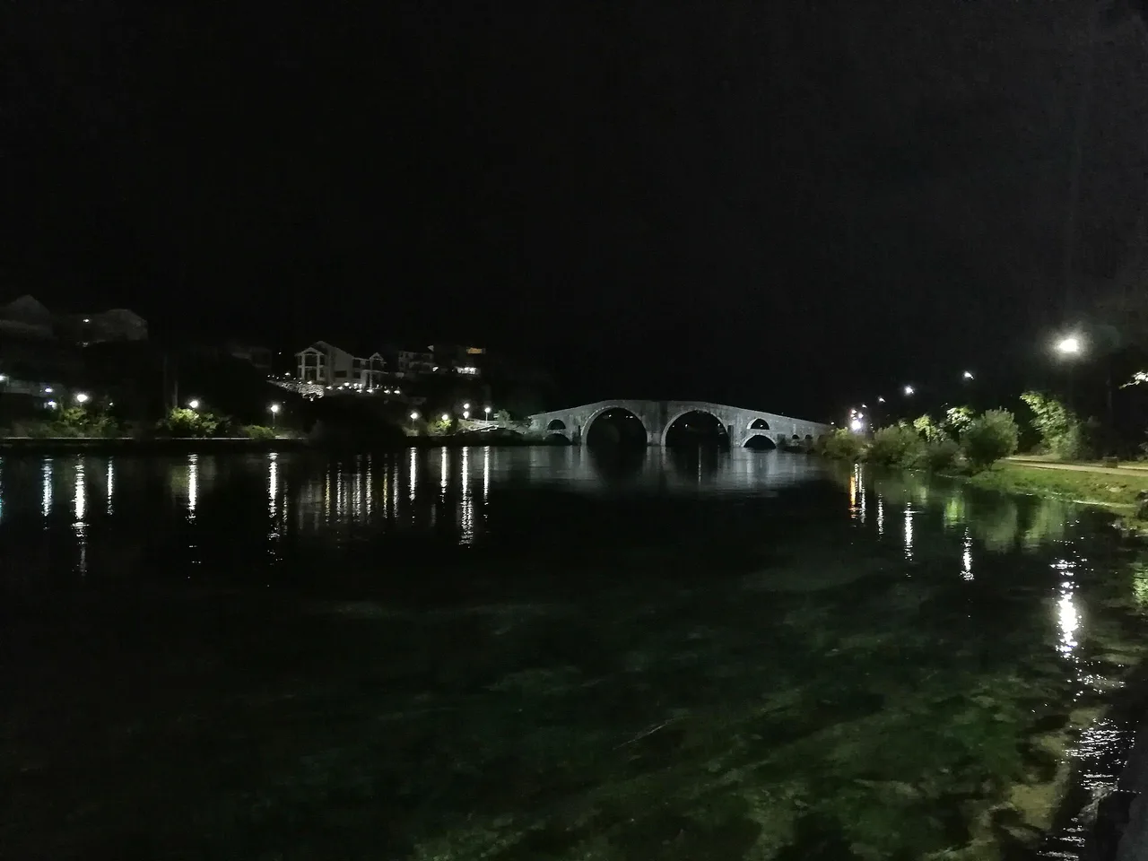 The stone Arslanagić Bridge at Trebinje with its two large and two small arches over the green Trebišnjica river
