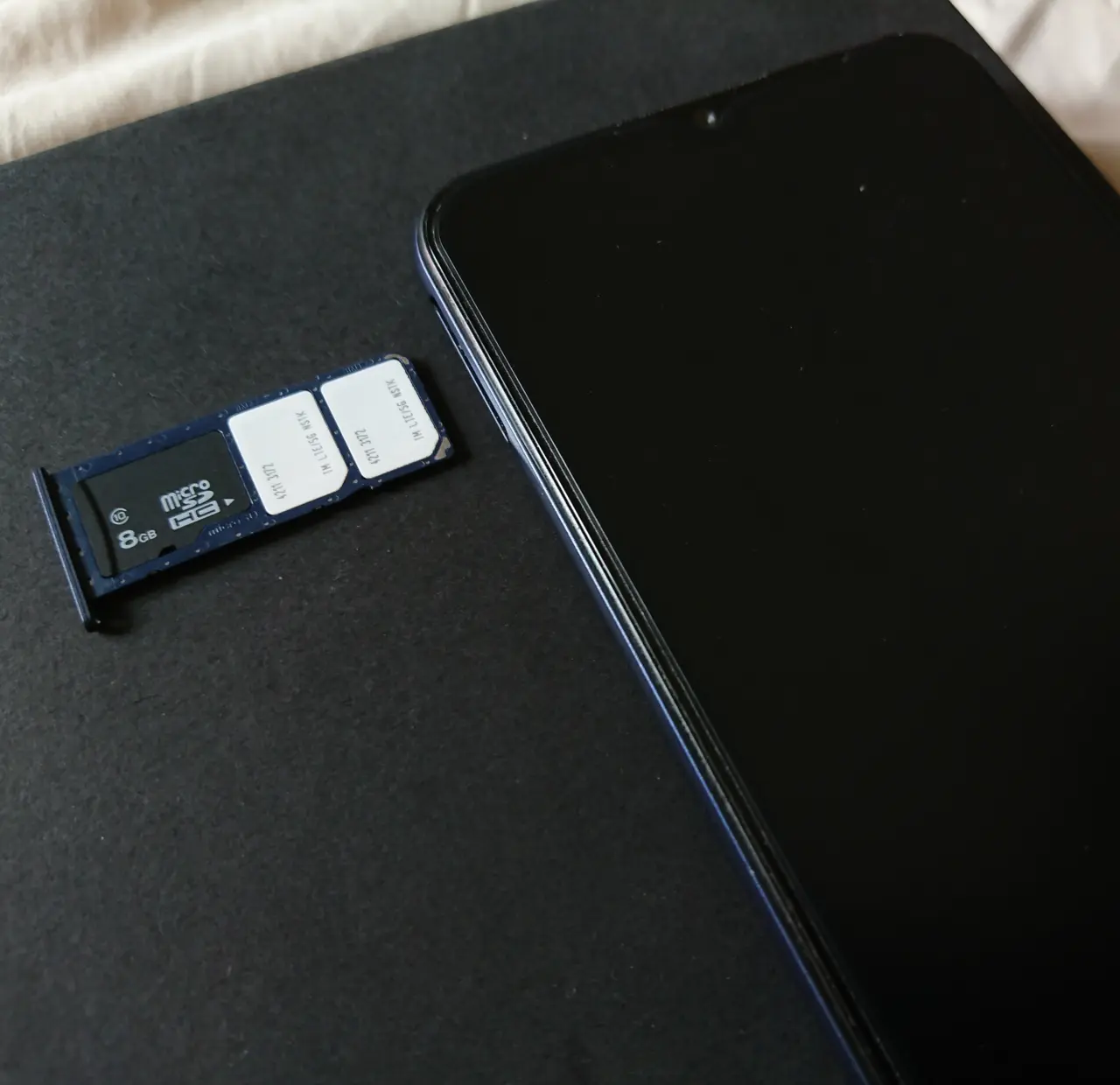A modern smartphone showing a dual SIM tray with two card slots