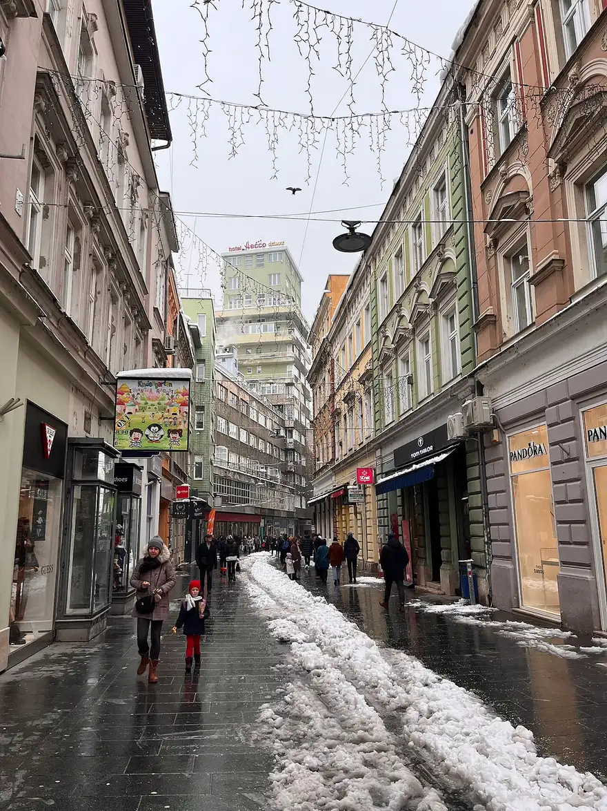 Shoppers on the pedestrian Ferhadija street in central Sarajevo, lined with shops and cafés