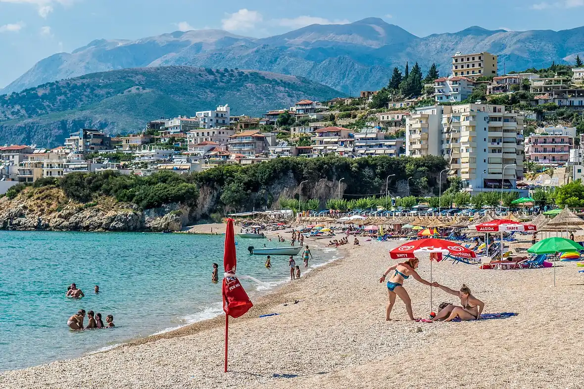 Sandy Potam beach at Himara on the Albanian Riviera with clear shallow water and hills