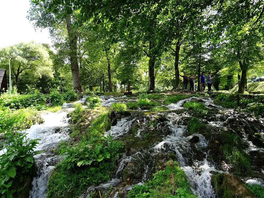 Small wooden watermills straddling green channels of the Pliva between the two lakes near Jajce