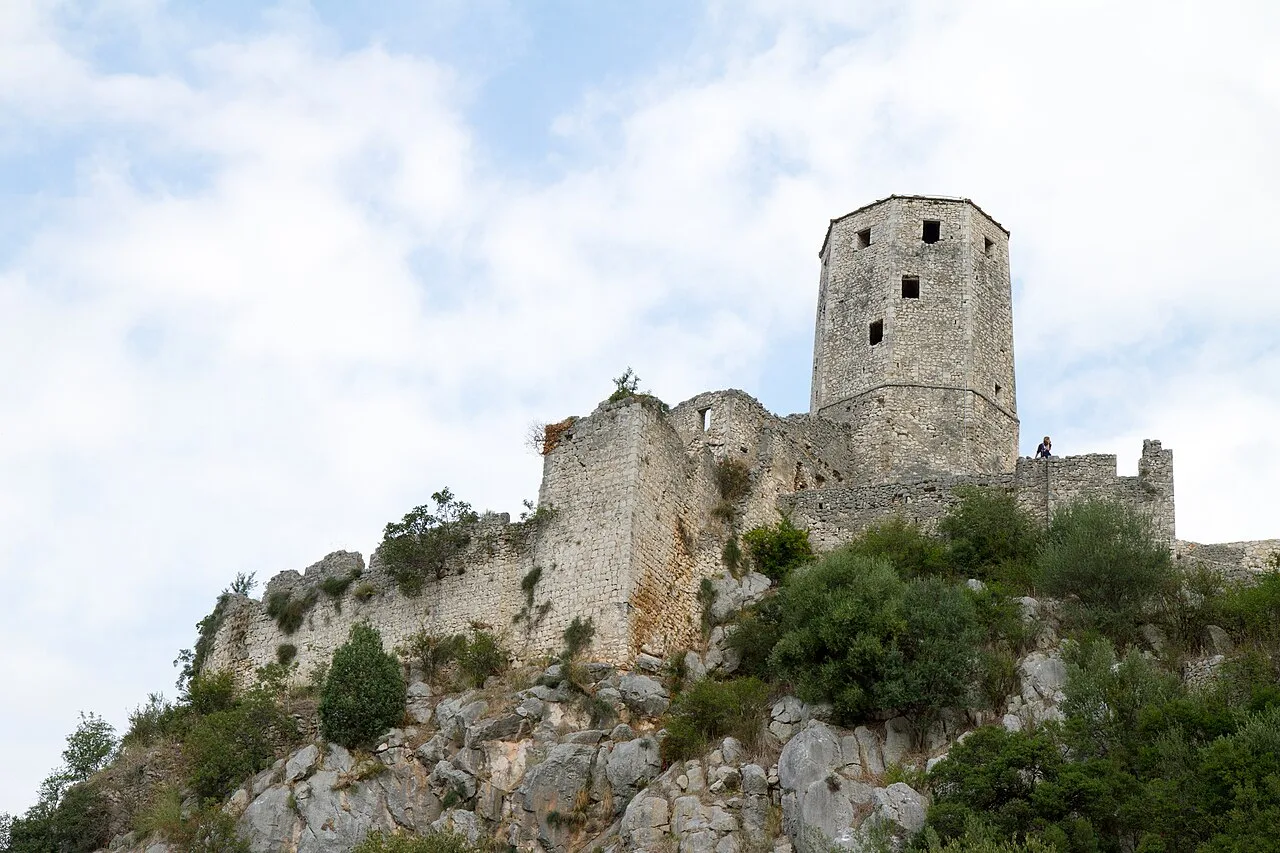 The stone citadel and octagonal tower of Pocitelj crowning its rocky hill above the Neretva