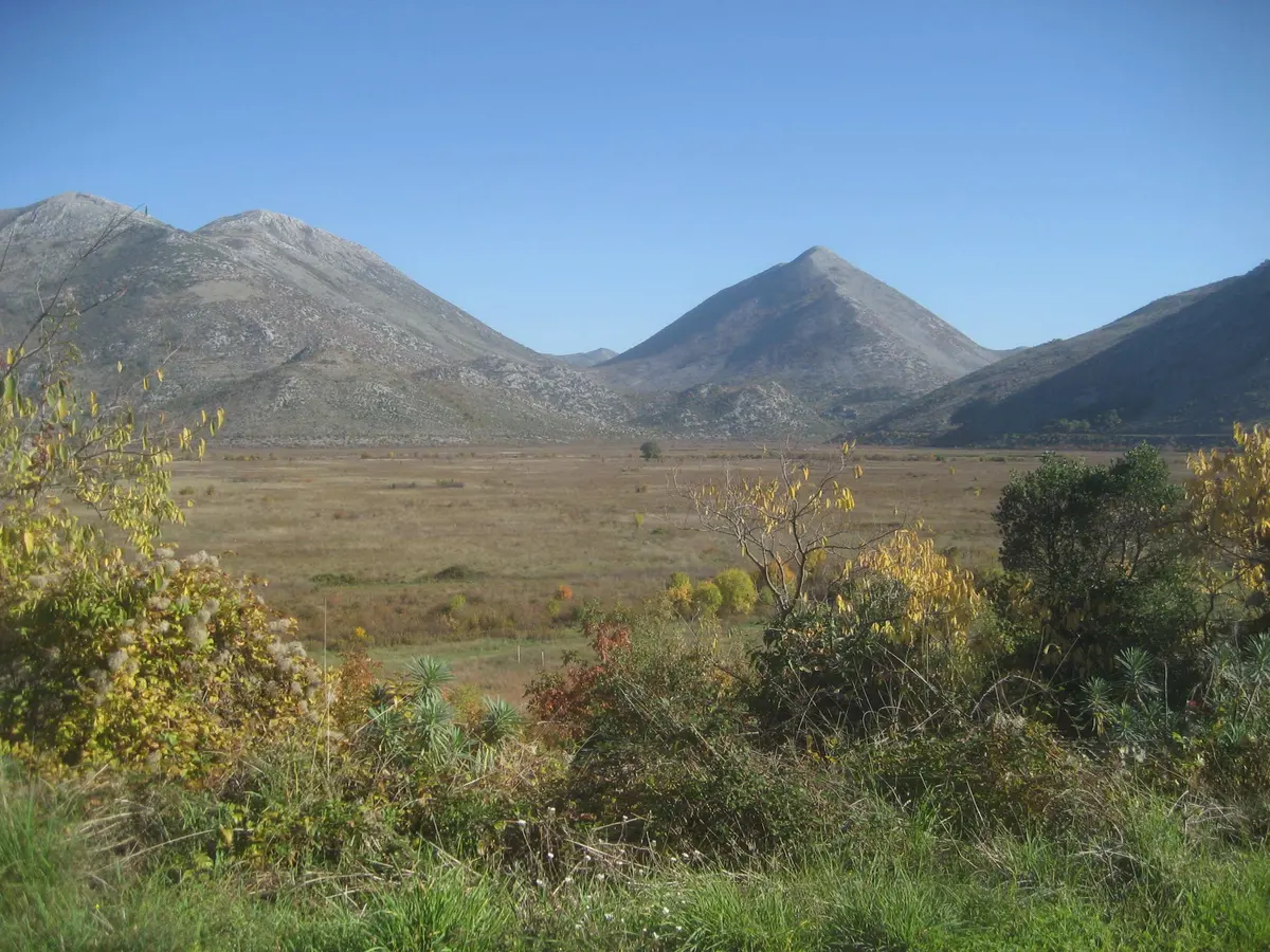 The bare karst mountains and golden autumn scrub of Popovo polje near Ravno, Herzegovina