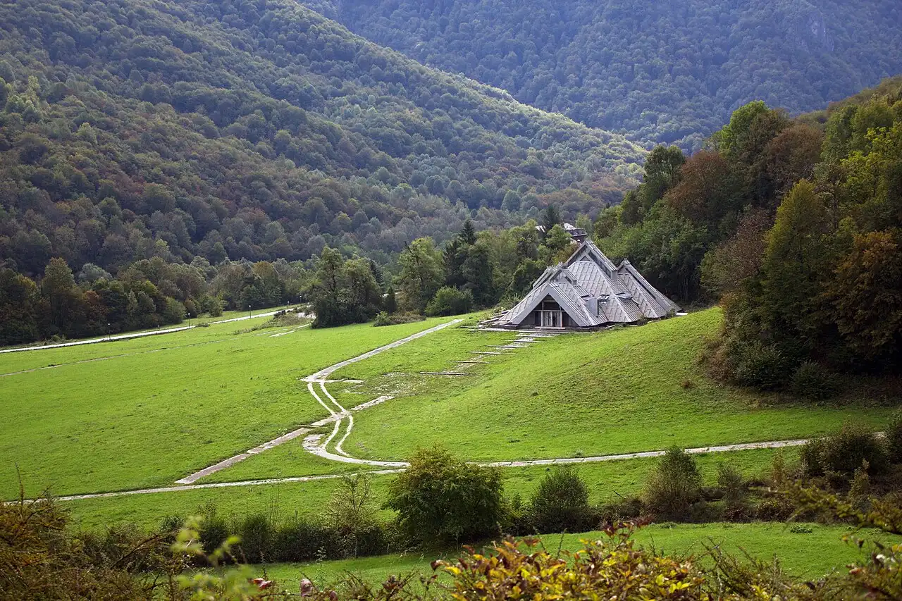 The concrete wings of the Tjentište war memorial rising from the hillside in Sutjeska National Park