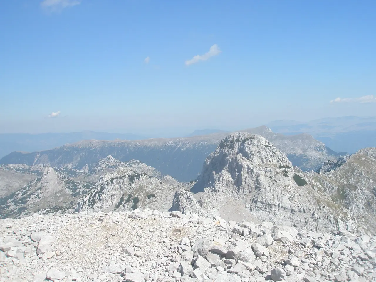 Bare white limestone summits of the Prenj massif under a clear sky, with no trees or water in sight