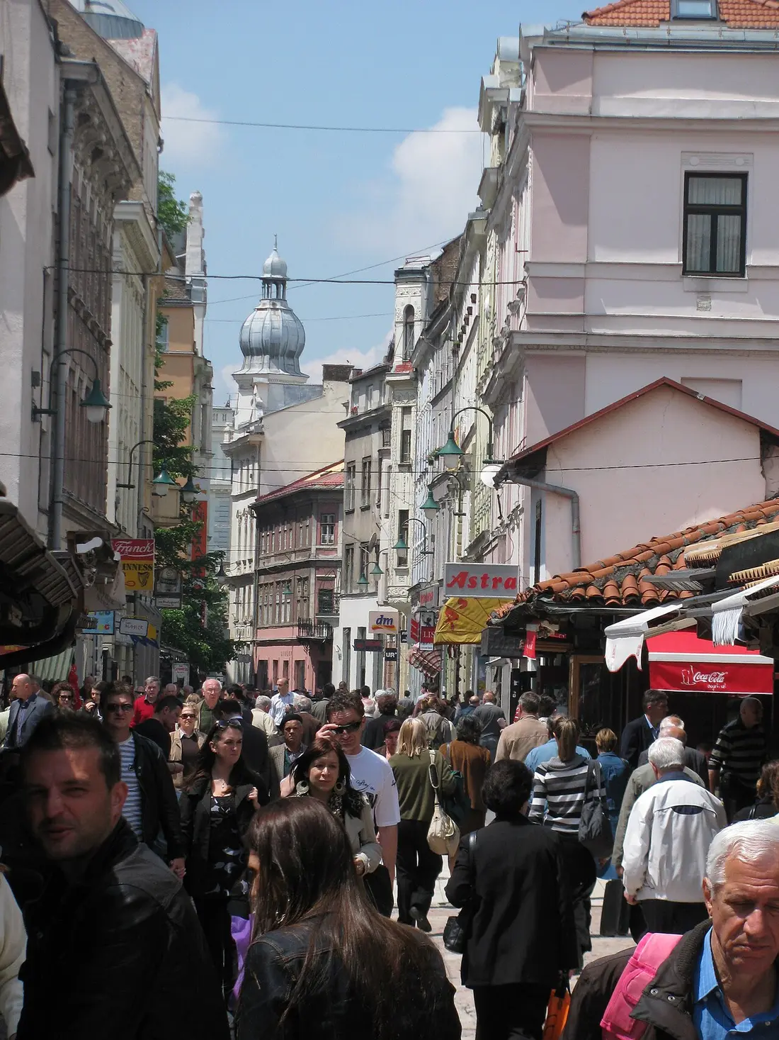 Crowds of people walking along the pedestrian Ferhadija street in central Sarajevo