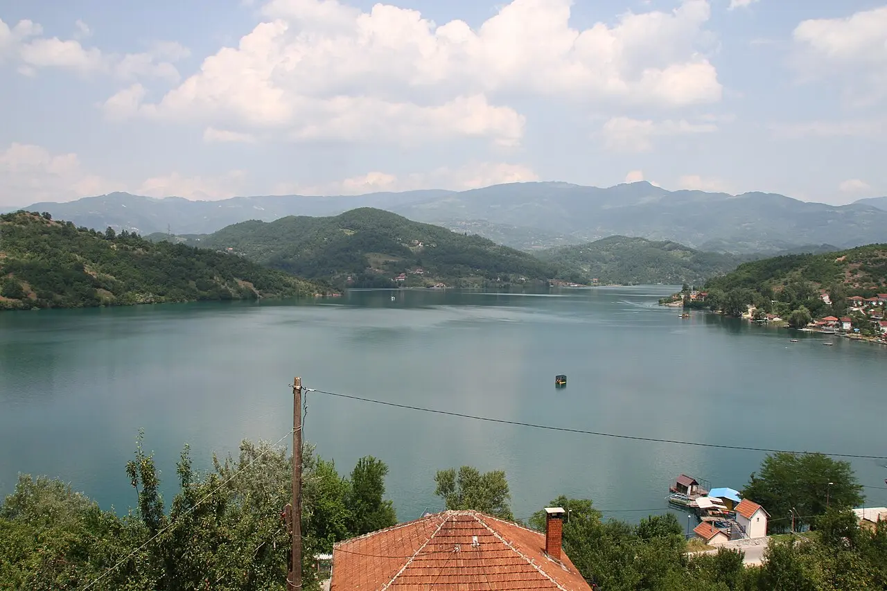 Turquoise Jablanica Lake reservoir on the Neretva with forested hills beyond