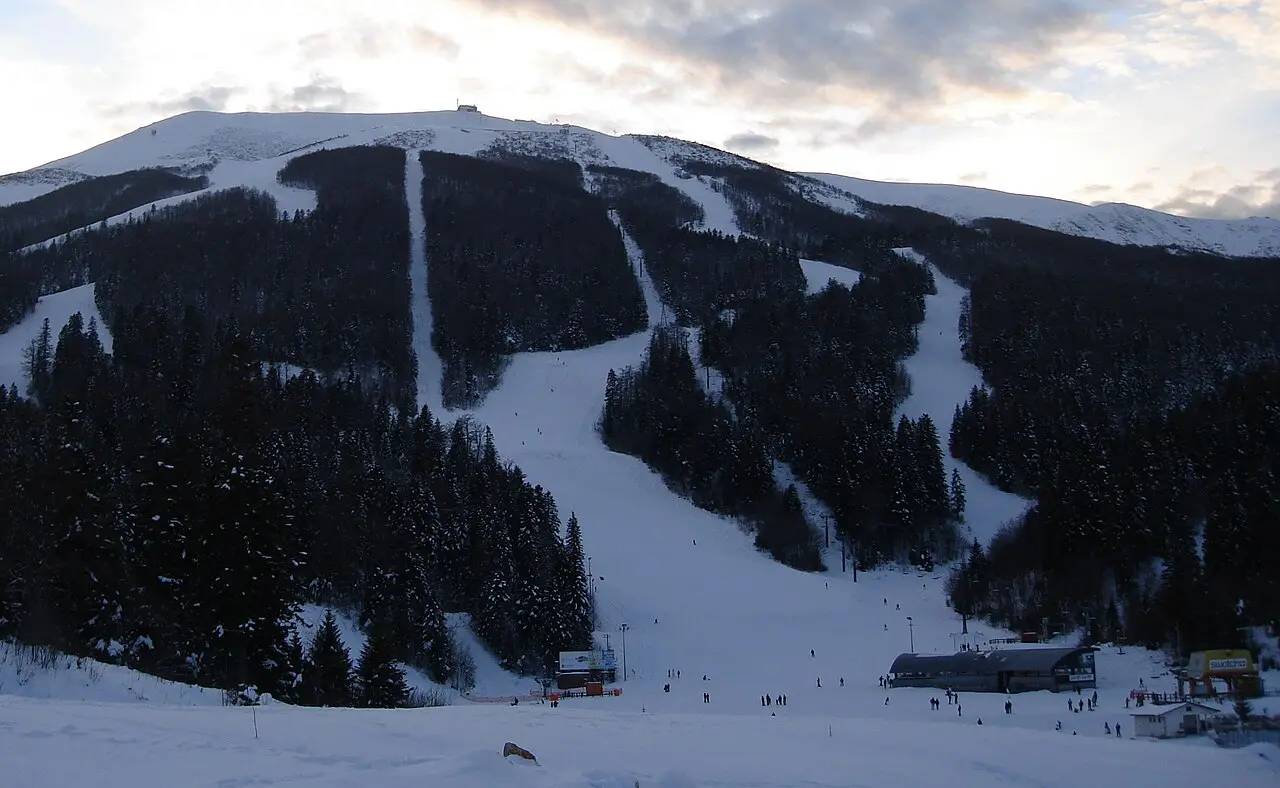 The open Olympic alpine slopes of Bjelašnica climbing toward the summit ridge above Babin Do
