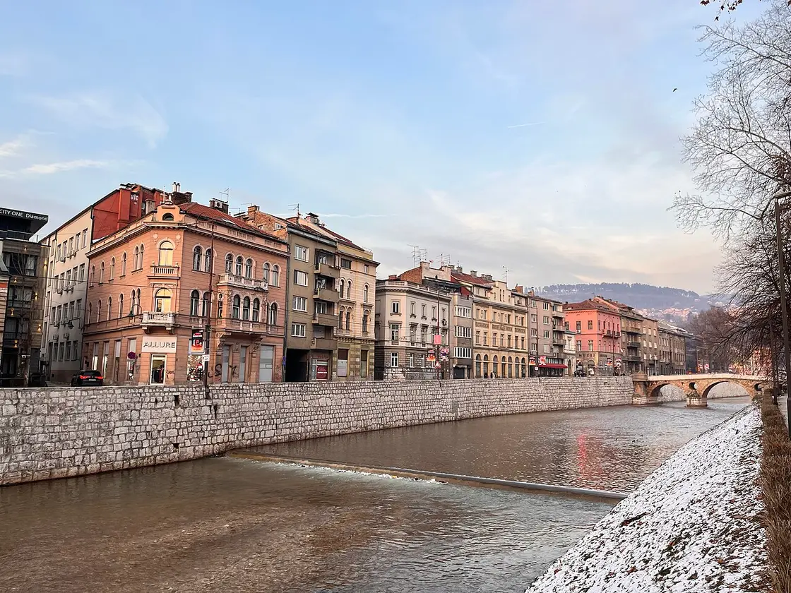 The Miljacka riverbank promenade near the Latin Bridge in central Sarajevo in winter light