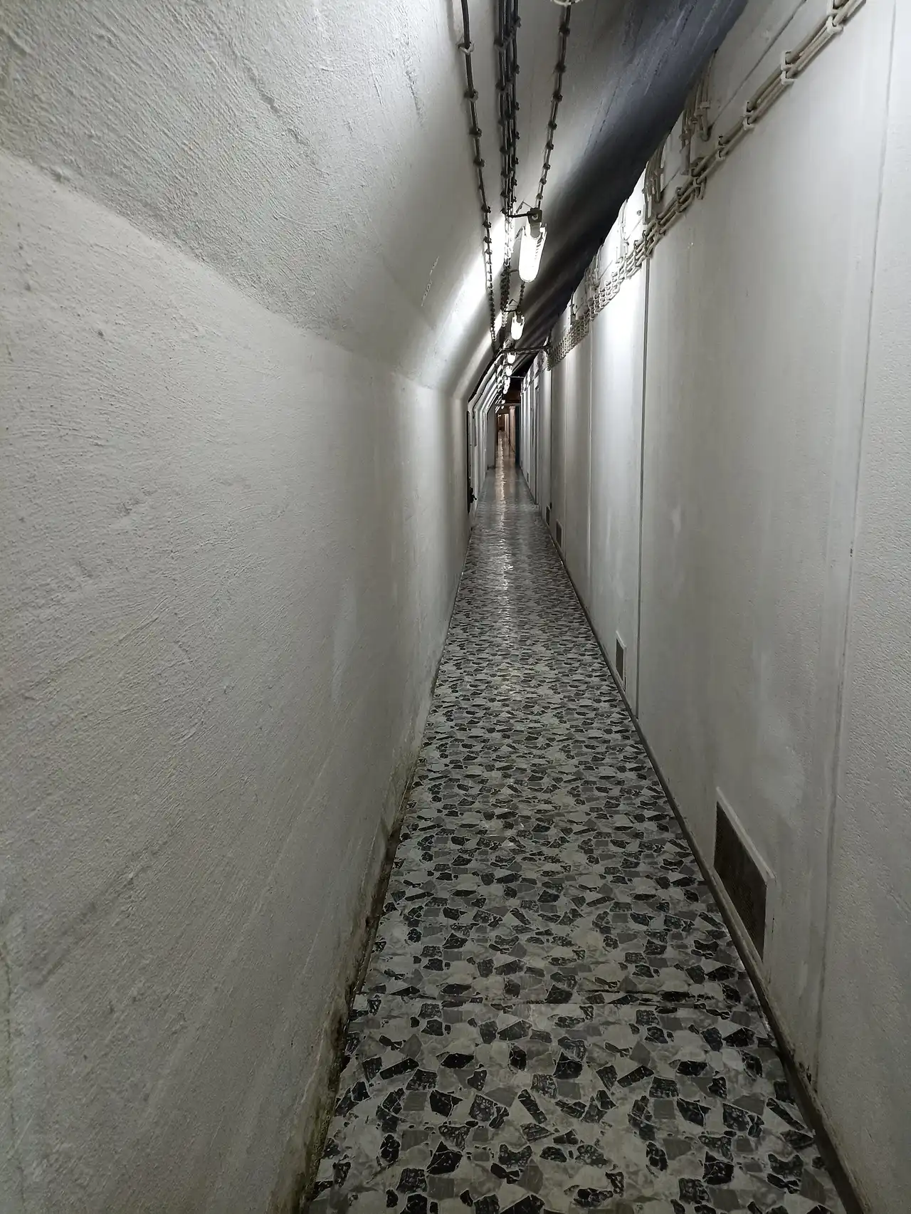Long lit perimeter corridor inside the ARK D-0 bunker near Konjic