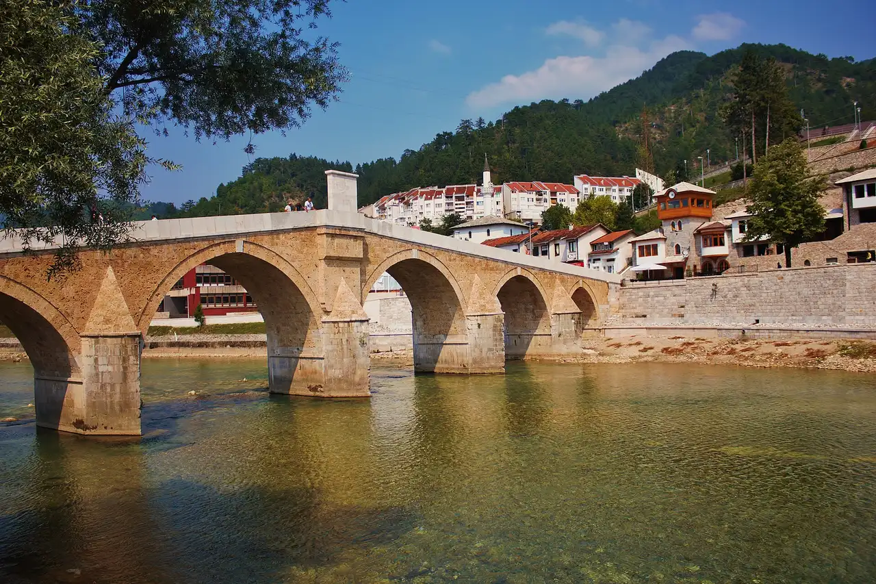Stone Ottoman bridge over the green Neretva river in Konjic