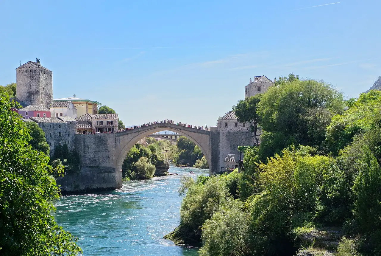 Stari Most in Mostar with people on the stone arch over the Neretva