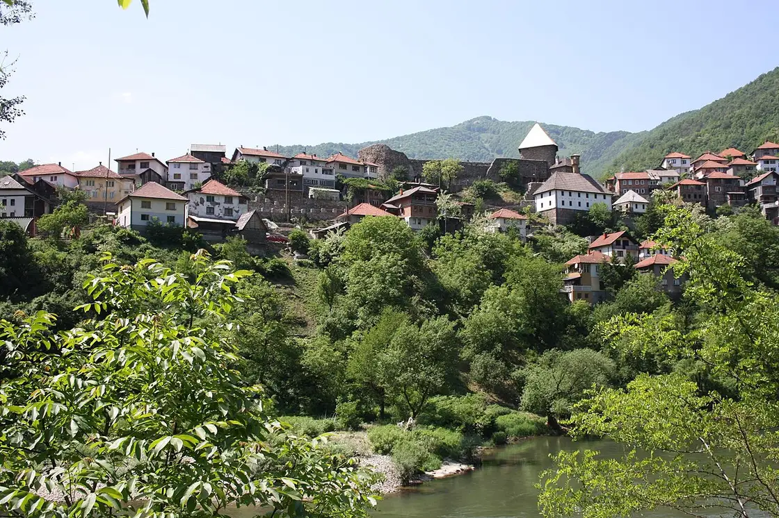 The stone-and-timber houses of Vranduk village stacked up the hillside above the green Bosna, the fortress keep and the white Ottoman mosque among them
