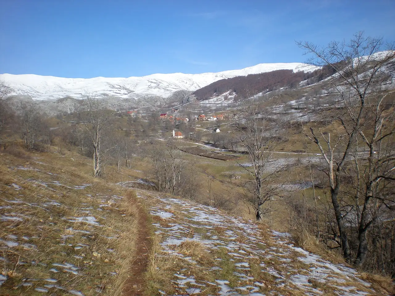 Lukomir village on the high Bjelašnica ridge above the Rakitnica canyon, patches of snow on the bare slopes and no trees in sight