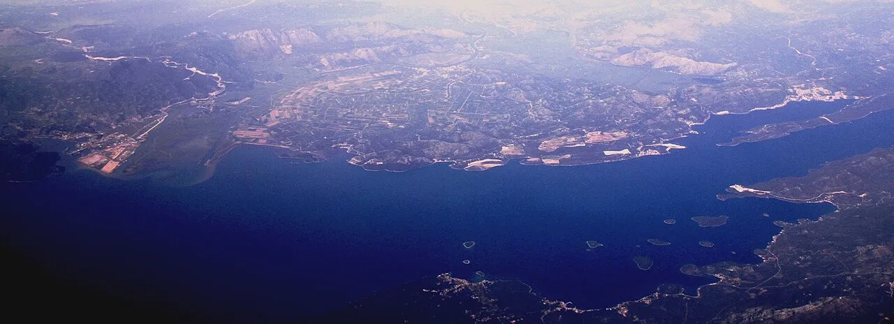 The wide green Neretva river delta and the Peljesac peninsula seen from above near Metkovic, where the inland road into Bosnia branches off the coast