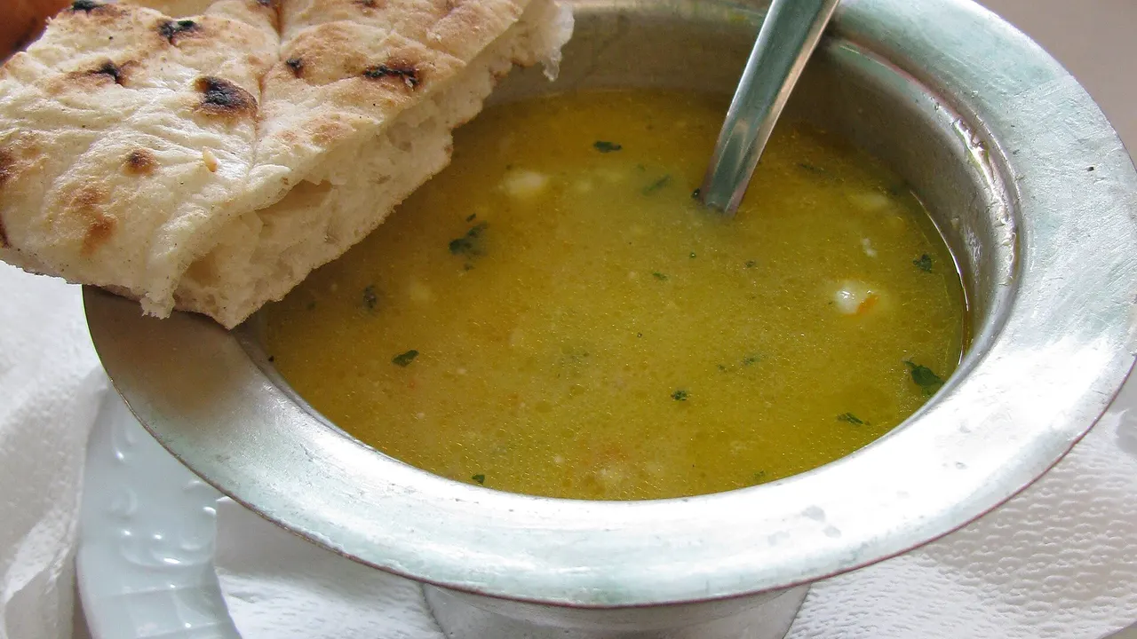 A bowl of begova čorba, Bosnian chicken and okra soup, served in a restaurant setting