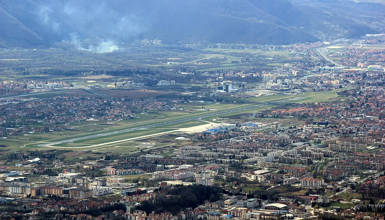 Aerial view of Sarajevo Airport and its single runway surrounded by the suburbs of Ilidza, roughly 12 km from the city centre
