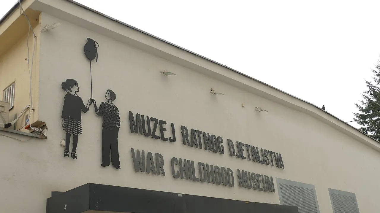 The facade of the War Childhood Museum in Sarajevo with its mural of a girl handing a boy a balloon shaped like a grenade
