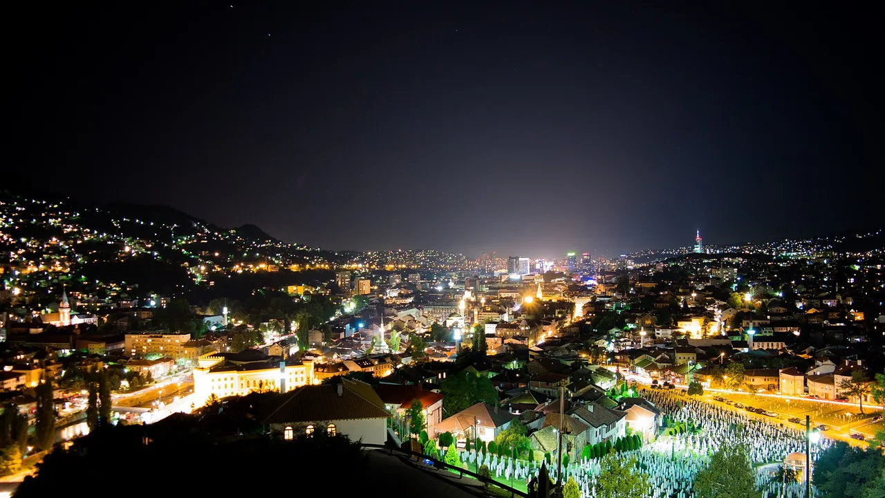 Sarajevo city lights spreading through the valley at night under a clear sky