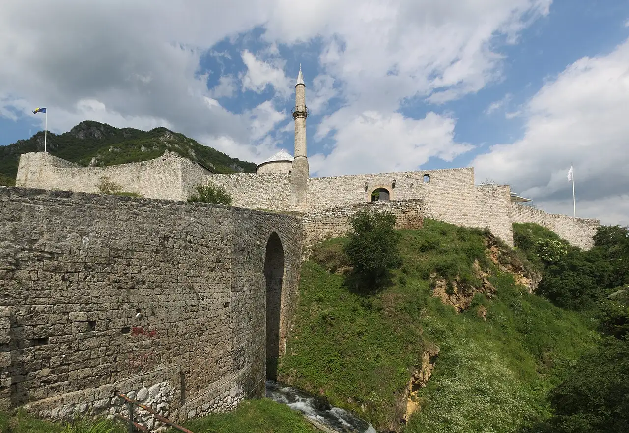 Stone walls of Travnik fortress on a green hillside above the old Ottoman vizier town