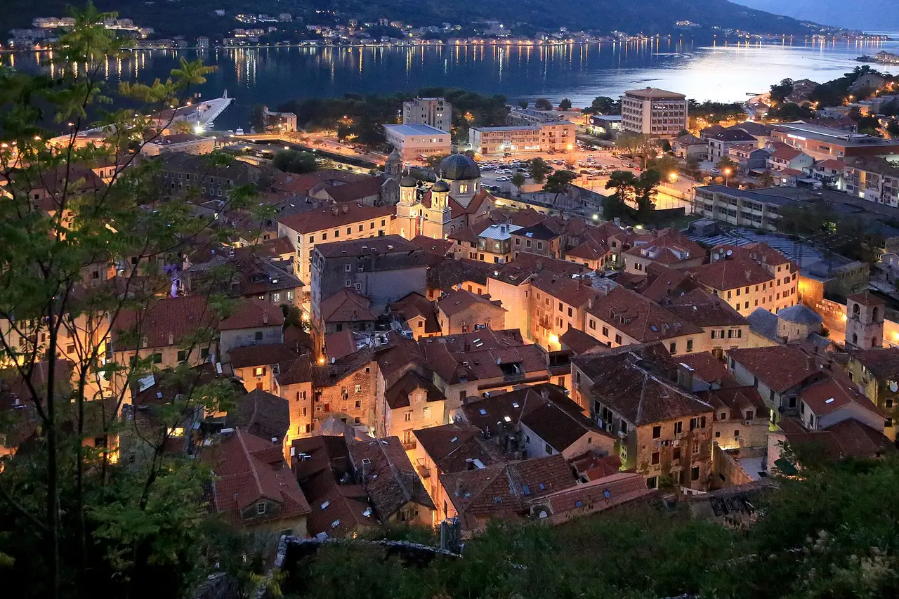 The Bay of Kotor seen from above, mountains dropping to the still water with the old town at the far end