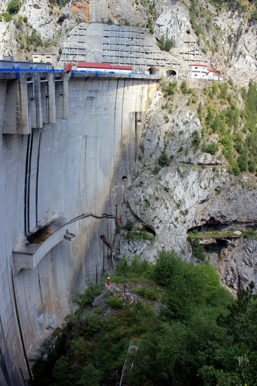The tall concrete arch of the Mratinje dam wall above the deep green Piva canyon in Montenegro