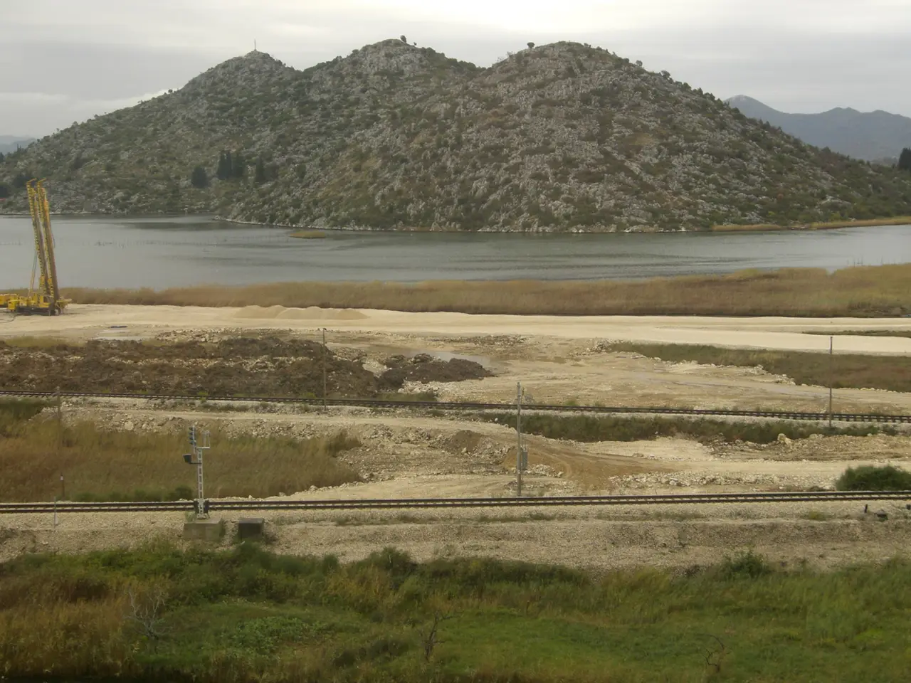 The Sarajevo-Mostar railway line running beside the Neretva and a green reservoir through the valley
