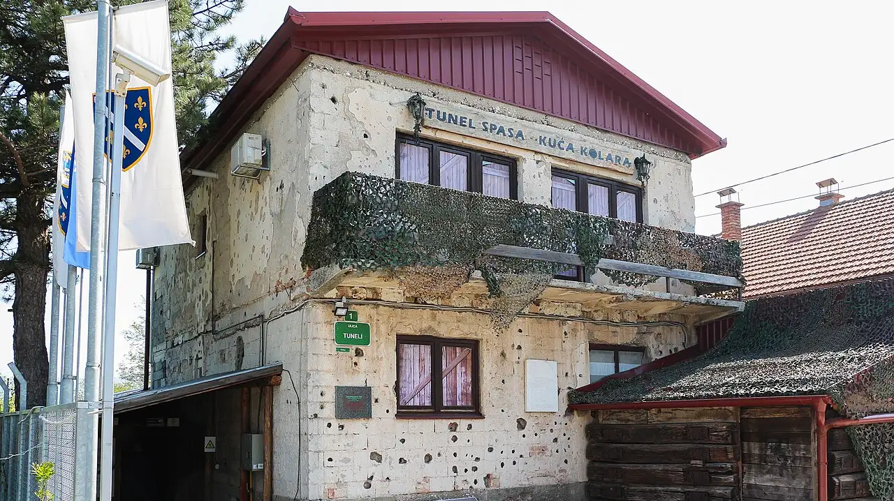 The shell-scarred Kolar family house at the Sarajevo War Tunnel museum, its façade lettered Tunel spasa - Kuća Kolara