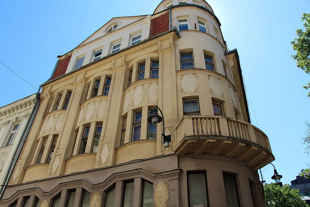 Pedestrian Ferhadija street in central Sarajevo with Austro-Hungarian façades, shop signs and people walking the paving