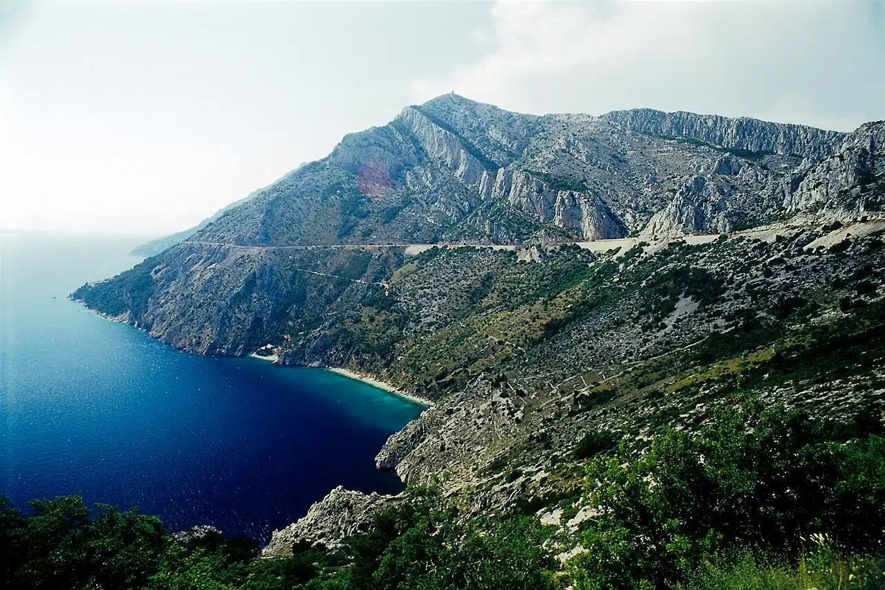 The Adriatic Highway hugging the steep coast below the Biokovo mountains, the scenic road the Split to Mostar bus follows before turning inland