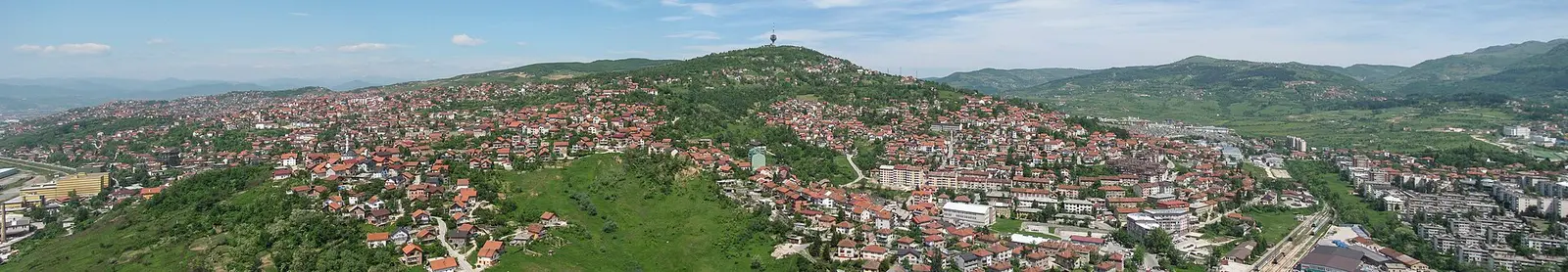 Panorama of Sarajevo filling its long valley below the northern hills, the destination at the end of the run from Split