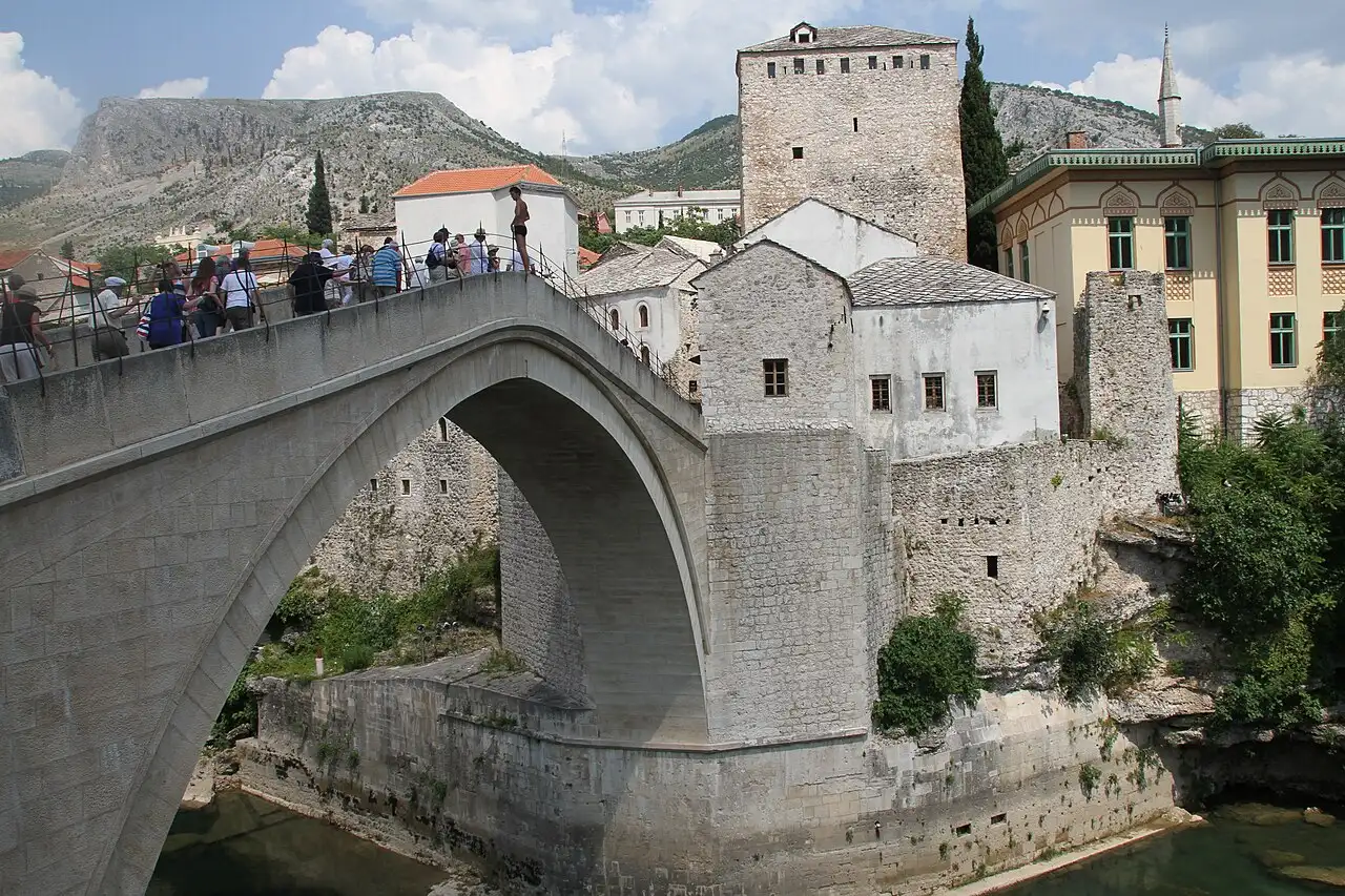 The stone approach and one of the towers of Stari Most seen from the cobbled Old Town lane in Mostar