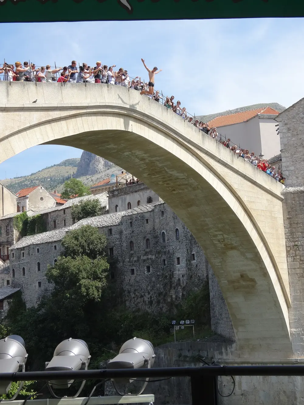 A local diver mid-leap from the parapet of Stari Most towards the Neretva far below