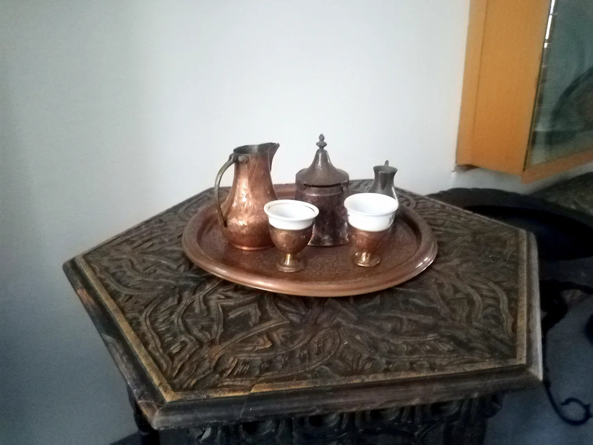 A Bosnian coffee set: copper džezva, small fildžan cup, sugar cube and a piece of Turkish delight on a tray