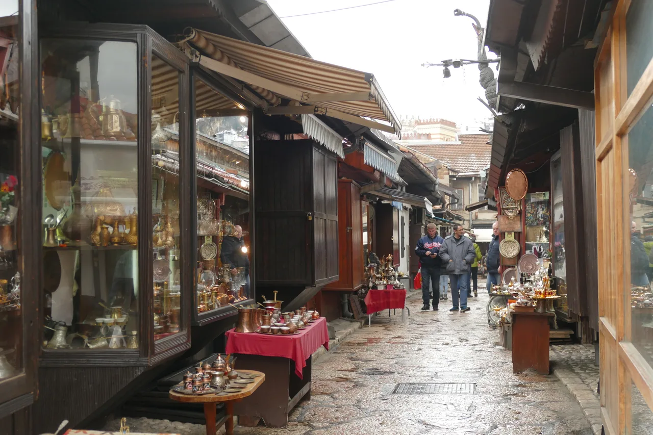 Coppersmith stalls with hammered trays, coffee sets and lamps along Kazandžiluk lane in Sarajevo bazaar