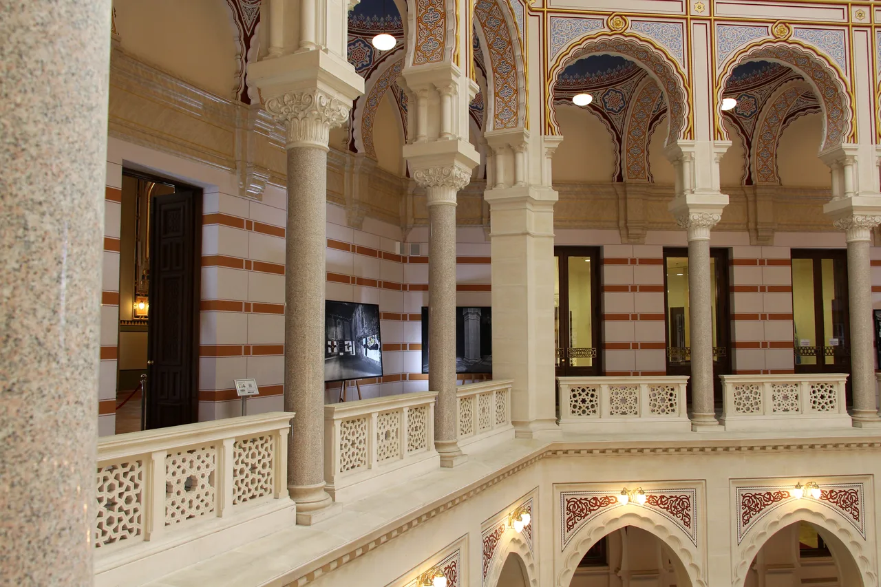 The restored pseudo-Moorish atrium of Sarajevo City Hall (Vijećnica) with arches and a stained-glass ceiling