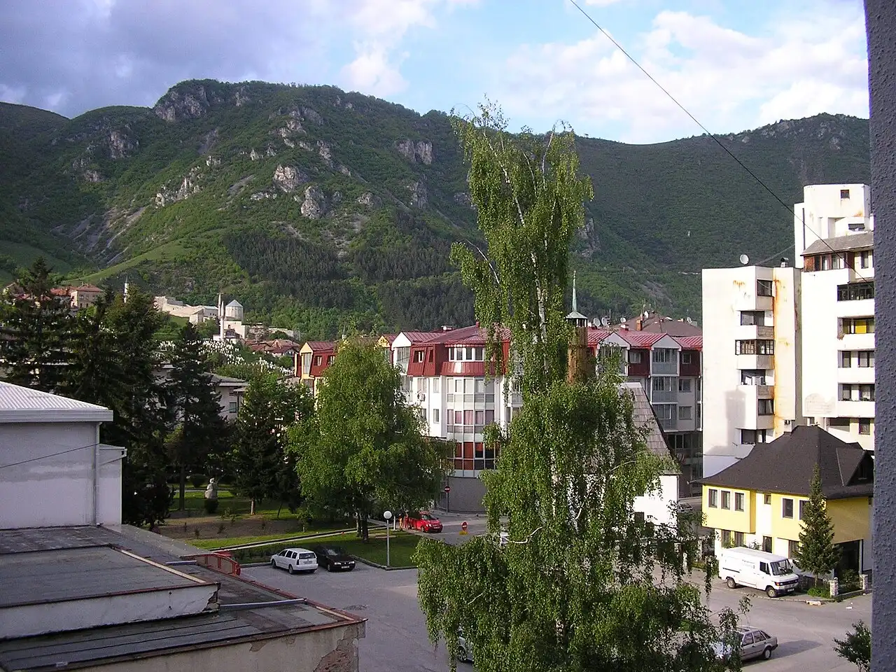 The town of Travnik in a steep green valley below the wooded slopes of Mount Vlasic