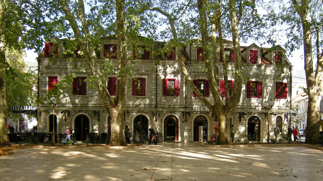 Rows of huge plane trees shading the main square of Trebinje outside the old town walls