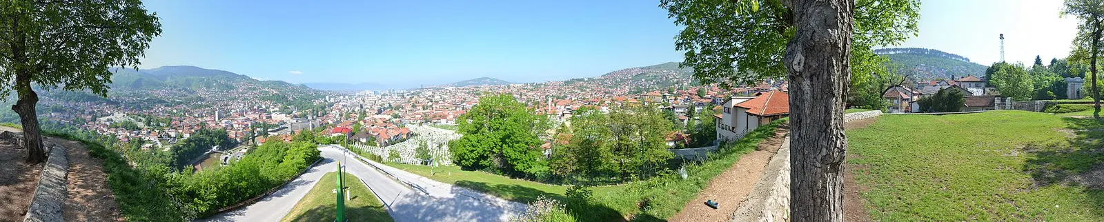 Panorama of Sarajevo spread through its valley, the destination roughly 108 km by road southwest of Tuzla airport