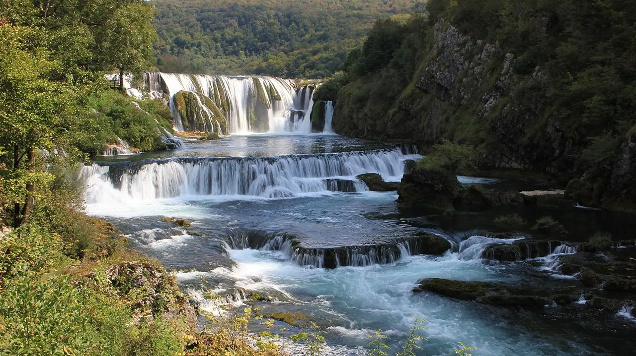Štrbački buk, a wide staircase of turquoise cascades on the Una river in Una National Park, forest all around