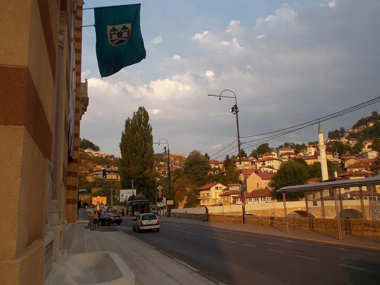 Close view of the ornate striped stone facade and arched windows of Vijećnica