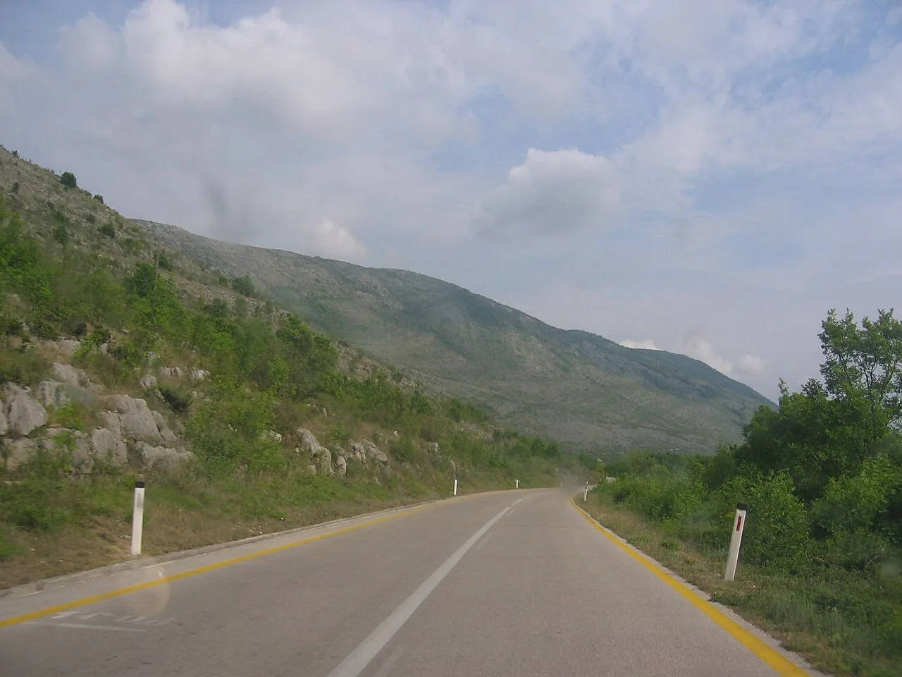 A two-lane road running along the bare karst ridge that edges Popovo polje in southern Herzegovina